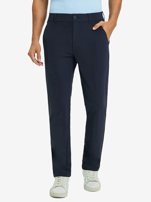 Front lower body view of model with hand in pocket, wearing quick dry casual dress pants in navy.