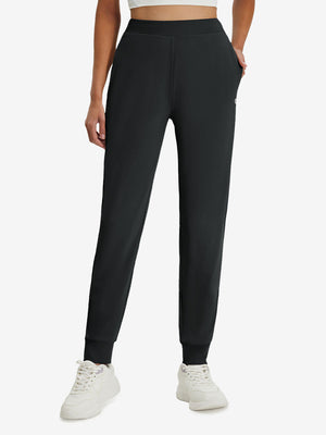 Front lower body shot of model wearing black women's lightweight athletic sweatpants
