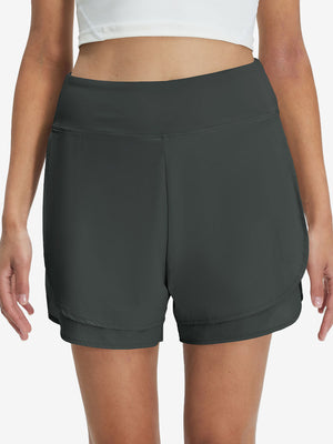Front lower body shot of model wearing dark grey women's gym golf shorts with liner pocket