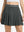 Front lower body shot of model wearing dark grey women's moisture-wicking athletic tennis skirts