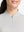 Front shot from nose to chest of model wearing light grey white women's q-zip pin striped texture golf shirts