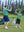 Father and son celebrating on course in Kids stripe golf polos, joyful green stripe moment