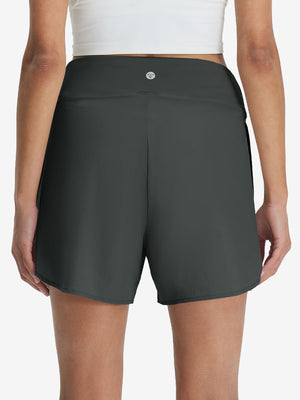Back lower body shot of model wearing dark grey women's gym golf shorts with liner pocket