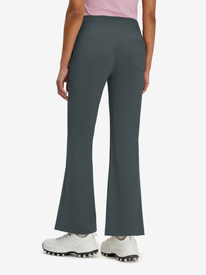 Back lower body shot of model wearing dark grey women's high waist stretch golf pants with pockets