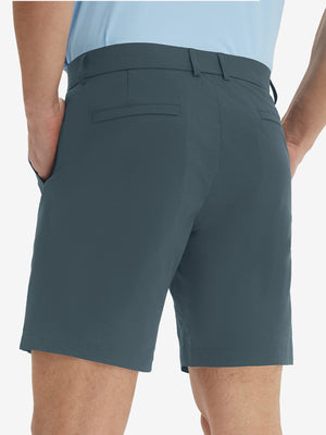 Back lower body view of model wearing the grey blue stretch soft flat front dress golf shorts, highlighting the rear design