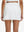 Back lower body shot of model wearing white high waist built-in short a-line golf skirt with 5 pockets