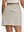 Back lower body shot of model wearing oyster gray women's stretch a-line golf skort with 7 pockets