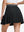 Back lower body shot of model wearing black women's moisture-wicking athletic tennis skirts