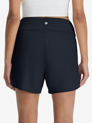 Back lower body shot of model wearing navy blue women's gym golf shorts with liner pocket