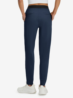 Back lower body shot of model wearing navy women's lightweight athletic sweatpants