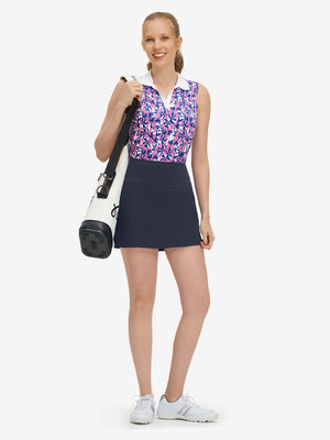 Front full body shot of model wearing navy high waist built-in short a-line golf skirt with 5 pockets