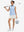 Front full body shot of model with golf gear wearing white women's gym golf shorts with liner pocket