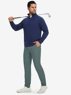 Model carrying a golf club on shoulder, wearing dark dusty blue lightweight moisture wicking dress pants.