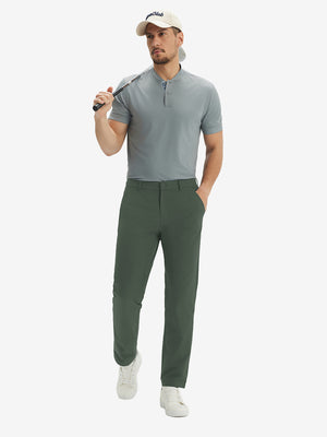 Full front view: model in grey green stretch quick dry casual golf pants with 4 pockets resting golf club on shoulder.