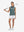Front full body with golf club in dusty blue of women's 4 buttons golf polo shirts.