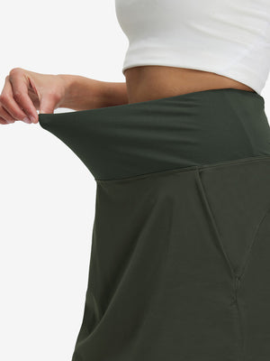 Detail view of elastic waistband on army green women's stretch a-line golf skort with 7 pockets