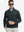 Front upper body view of model wearing lightweight golf quarter zip pullover in dark grey, relaxed fit.
