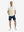 Front full body shot of model exercising in cream cool print plain button up shirts
