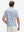 Back waist-up shot of model wearing white navy dolphin performance quick dry print golf polos.