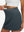 Detail view of elastic waistband on dark grey high waist built-in short a-line golf skirt with 5 pockets