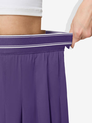 Detail view of elastic waistband on dark purple women's moisture-wicking athletic tennis skirts