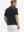 Back half body shot of model wearing rich black grid performance reflective checked collar golf shirt