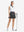 Front full body shot of model exercising in white women's collared v neck quick dry tank tops