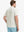 Back half-body view wearing Everyday Collarless Jersey Shirt in CREAM.