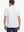 Back view of model in Light Pink Aqua Blue Stripe Performance Stripe Golf Shirt