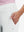 Side view of pocket on white women's high waist stretch golf pants with pockets
