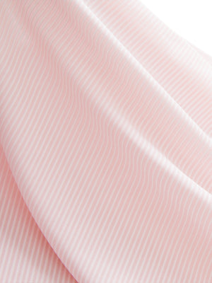 Close-up texture of light pink white women's q-zip pin striped texture golf shirts fabric showing pin striped weave detail.