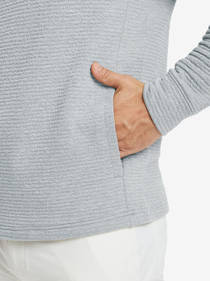 Close-up of pocket detail, single hand inside texture solid hoodies pullover, casual style in light grey heather.