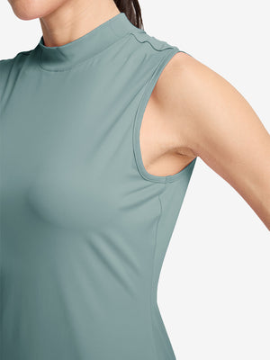 Detail view of armhole on dusty blue women's moisture-wicking mock neck sleeveless golf tops