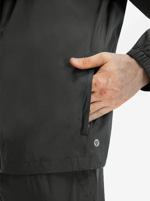 Detail view of outer pocket on dark grey waterproof lightweight rain jacket with hood
