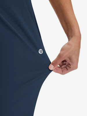 View showing loose fit of navy women's high waist stretch golf pants with pockets