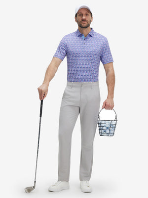 Full-body shot of model holding a golf club in pink purple flower performance quick dry print golf polos.