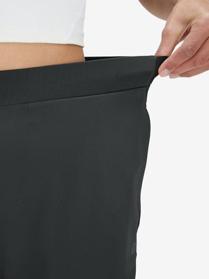 Detail view showing waist stretch on black women's lightweight athletic sweatpants