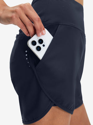 Side view of pocket on navy women's high waist 2 in 1 quick dry shorts with 7 pockets