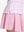Detail view of hem on pink purple stripes women's sleeveless q-zip print quick dry golf tops