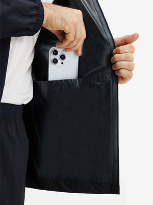 Detail view of inner pocket on navy waterproof lightweight rain jacket with hood