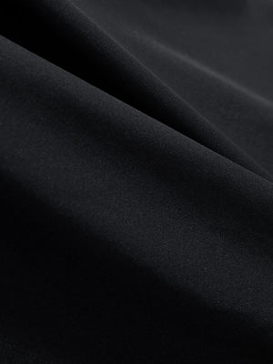 Close-up texture of black women's athletic quarter zip tank tops fabric showing detailed athletic material and weave.
