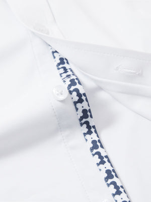 Detail view of buttons on white cool print plain button up shirts