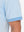Detail view of hem on light blue moisture wicking jacquard golf shirts