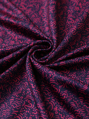 Close-up of navy rose abstract performance jersey print polo fabric showing breathable texture.