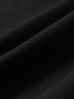 Close-up of black stretch quick dry casual golf pants with 4 pockets fabric texture.