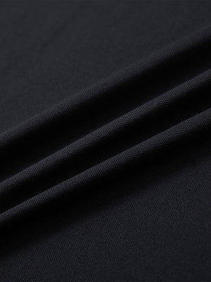 Close-up of black long sleeve solid jersey polo fabric texture showing soft knit and smooth finish details.