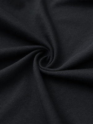 Fabric close-up of black cotton blend pique plain shirt, breathable pique fabric texture.