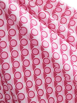 Close-up texture of white pink geometric women's sleeveless q-zip print quick dry golf tops fabric showing detailed print and quick dry weave.