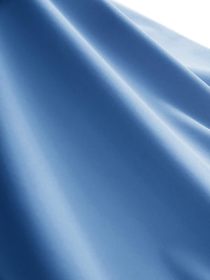 Close-up texture of light blue women's moisture-wicking mock neck sleeveless golf tops fabric showing breathable weave detail.