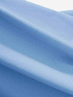 Close-up texture of light blue women's 4 buttons golf polo shirts fabric showing detailed knit weave.